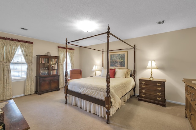 carpeted bedroom featuring a textured ceiling