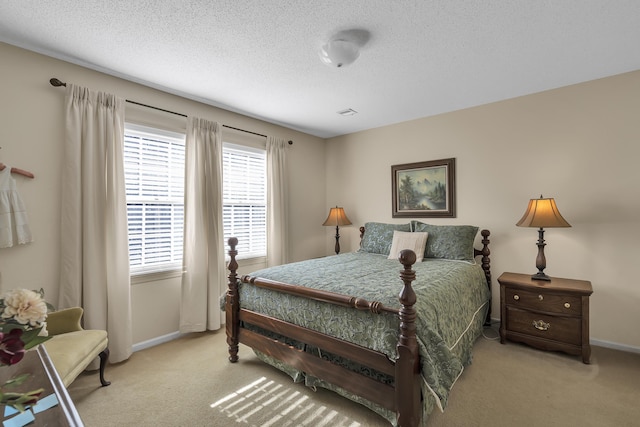 carpeted bedroom featuring a textured ceiling