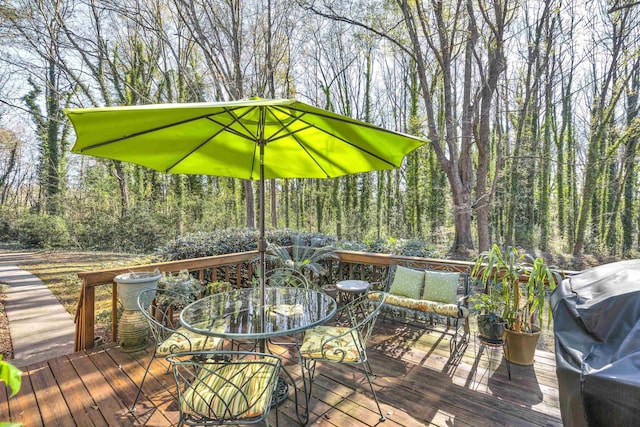 deck with area for grilling and outdoor lounge area