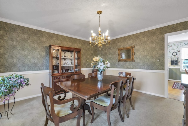 dining room featuring crown molding, carpet, and a notable chandelier