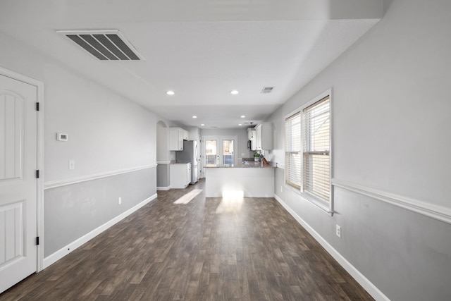 unfurnished living room with french doors and dark wood-type flooring