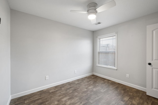 unfurnished room featuring ceiling fan and dark wood-type flooring