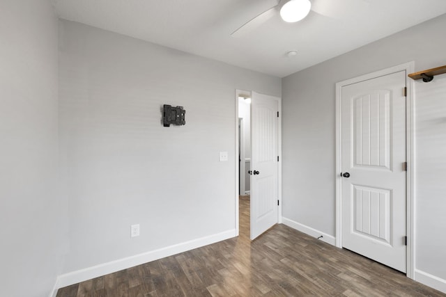 unfurnished bedroom with ceiling fan and dark hardwood / wood-style floors