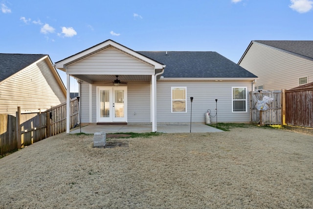 rear view of property with ceiling fan, a yard, a patio, and french doors