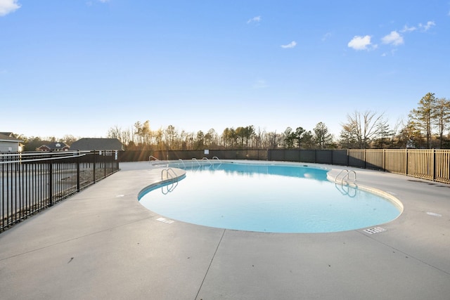 view of swimming pool with a patio area