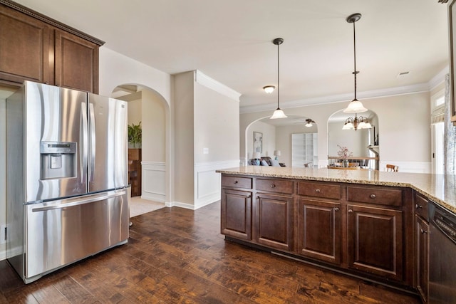 kitchen with pendant lighting, dark hardwood / wood-style floors, appliances with stainless steel finishes, dark brown cabinets, and light stone counters