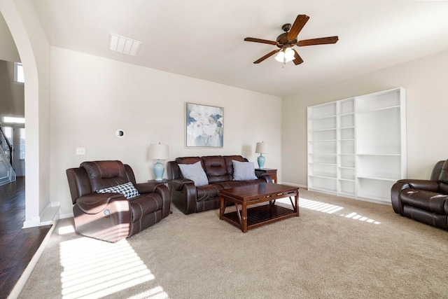 living room with ceiling fan and carpet floors