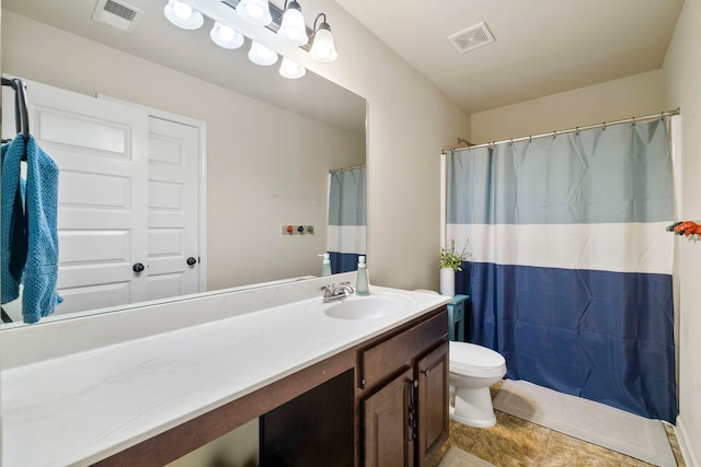 bathroom featuring tile patterned flooring, vanity, and toilet