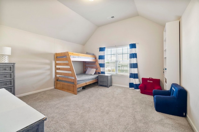 bedroom with carpet and vaulted ceiling