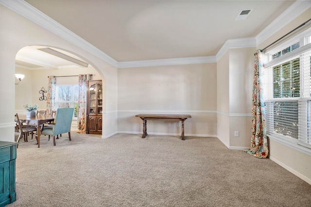 interior space featuring light carpet, plenty of natural light, and crown molding