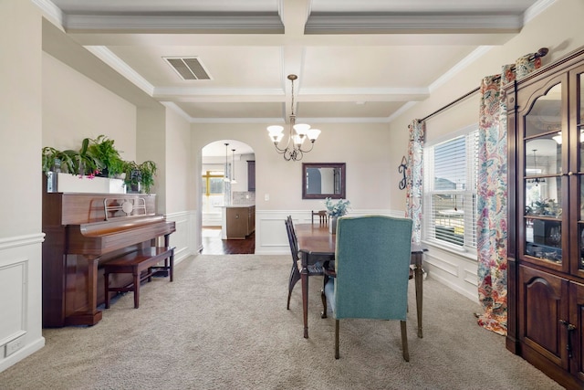 carpeted dining area featuring beamed ceiling, crown molding, coffered ceiling, and a notable chandelier