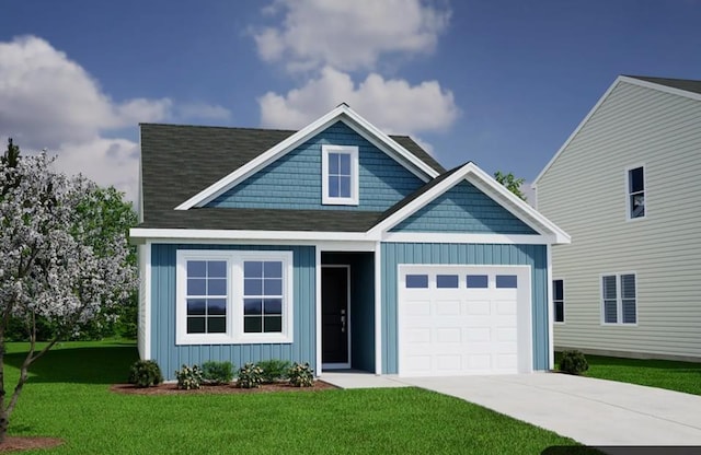 view of front of property with a front yard and a garage