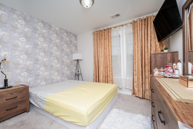 bedroom featuring light colored carpet