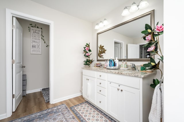 bathroom with hardwood / wood-style floors and vanity