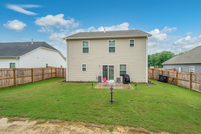 back of property with a patio area and a lawn