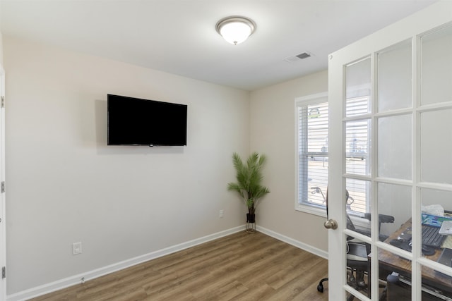 home office featuring french doors and wood-type flooring