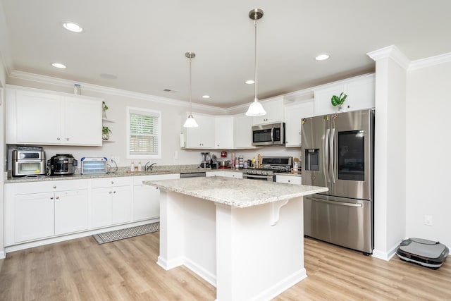 kitchen with white cabinets, stainless steel appliances, and a center island