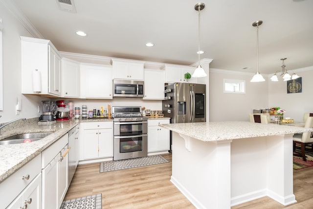 kitchen featuring sink, white cabinets, a breakfast bar area, and stainless steel appliances