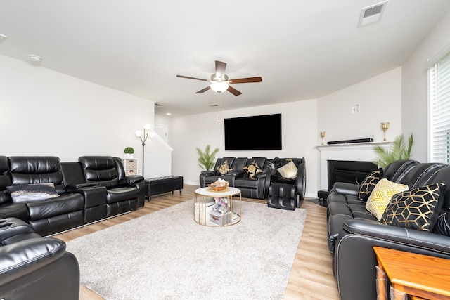 living room with ceiling fan and light wood-type flooring