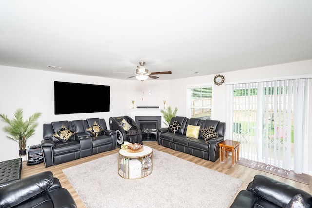 living room featuring light wood-type flooring and ceiling fan