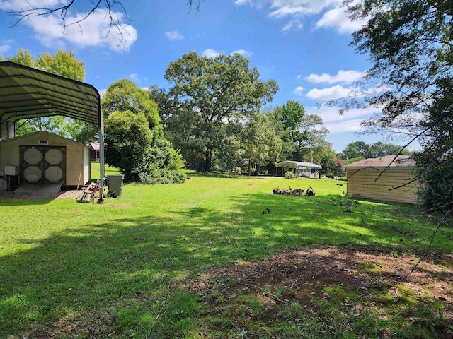 view of yard with a storage unit and a carport