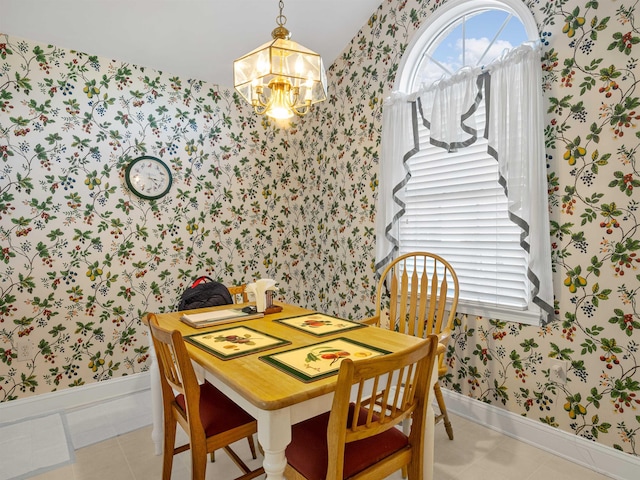 tiled dining space featuring a notable chandelier