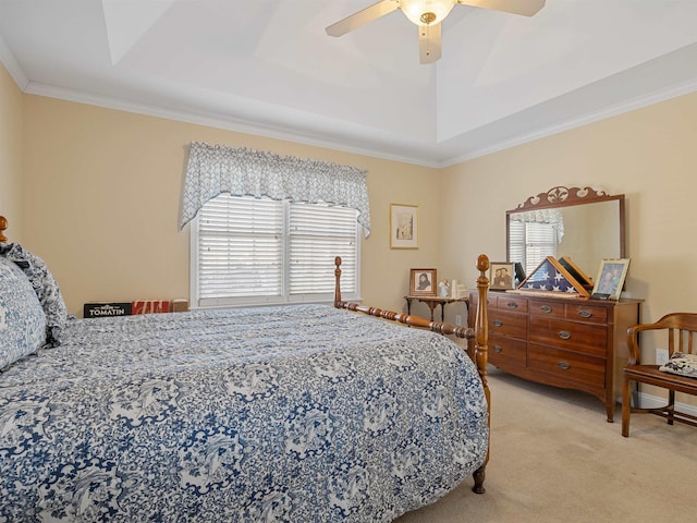 bedroom with ceiling fan, light colored carpet, crown molding, and a tray ceiling