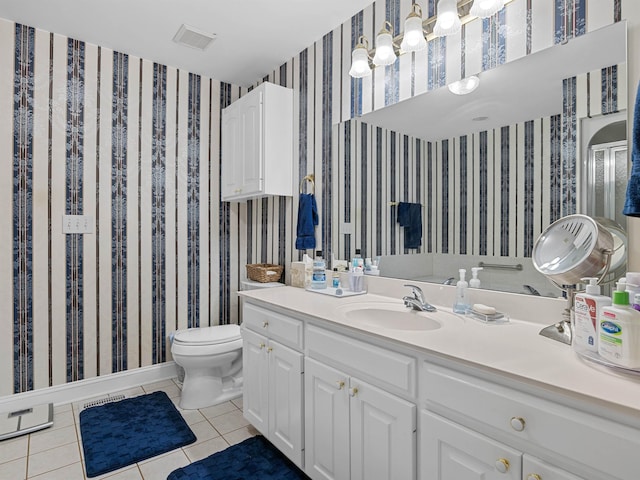 bathroom with tile patterned floors, vanity, and toilet