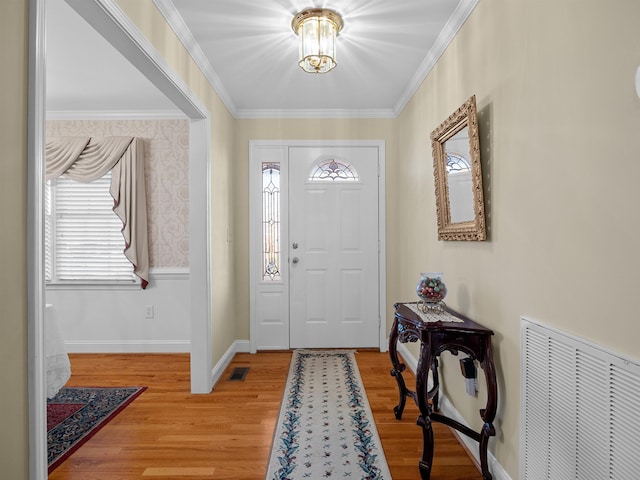 entrance foyer with wood-type flooring and crown molding