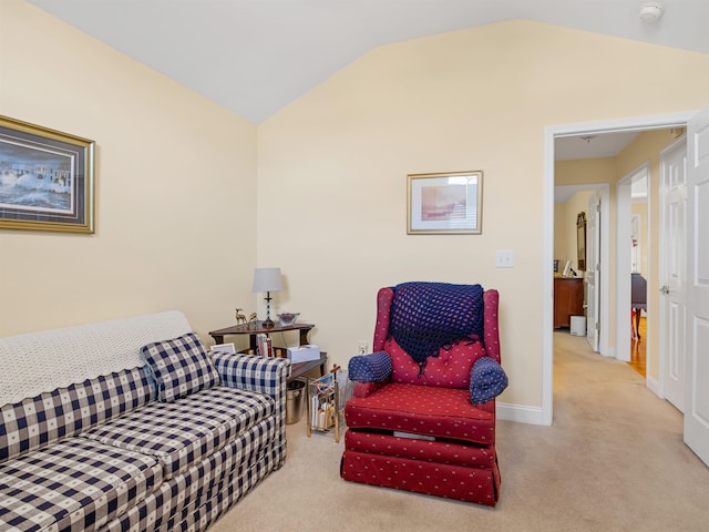 living room with light colored carpet and vaulted ceiling