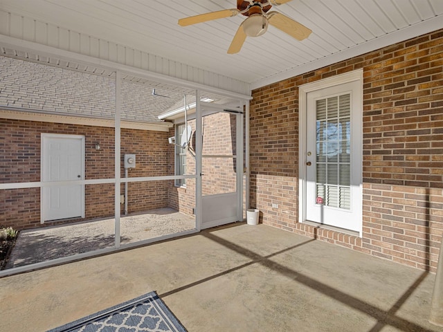 unfurnished sunroom with ceiling fan