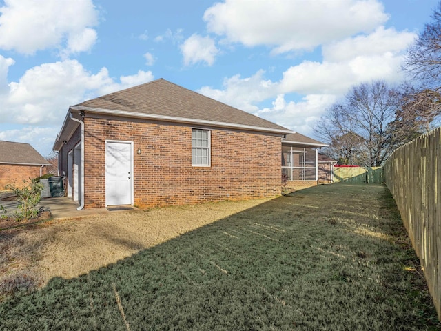 rear view of property with a lawn