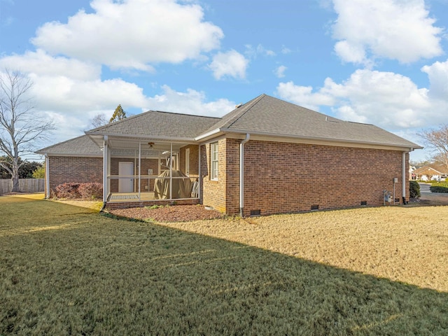 back of house featuring a yard and ceiling fan