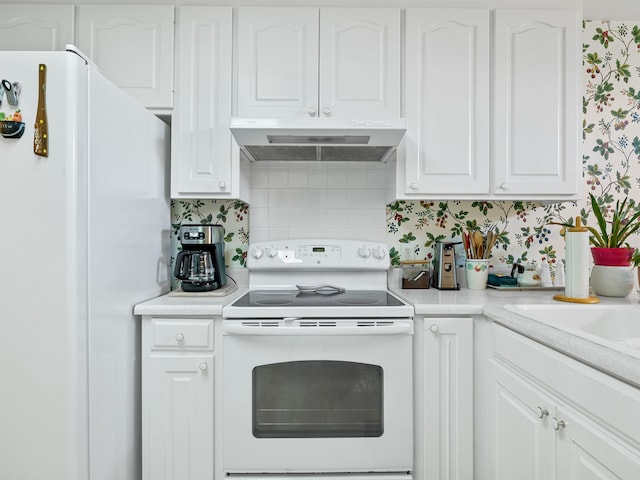 kitchen with backsplash, white cabinetry, and white appliances