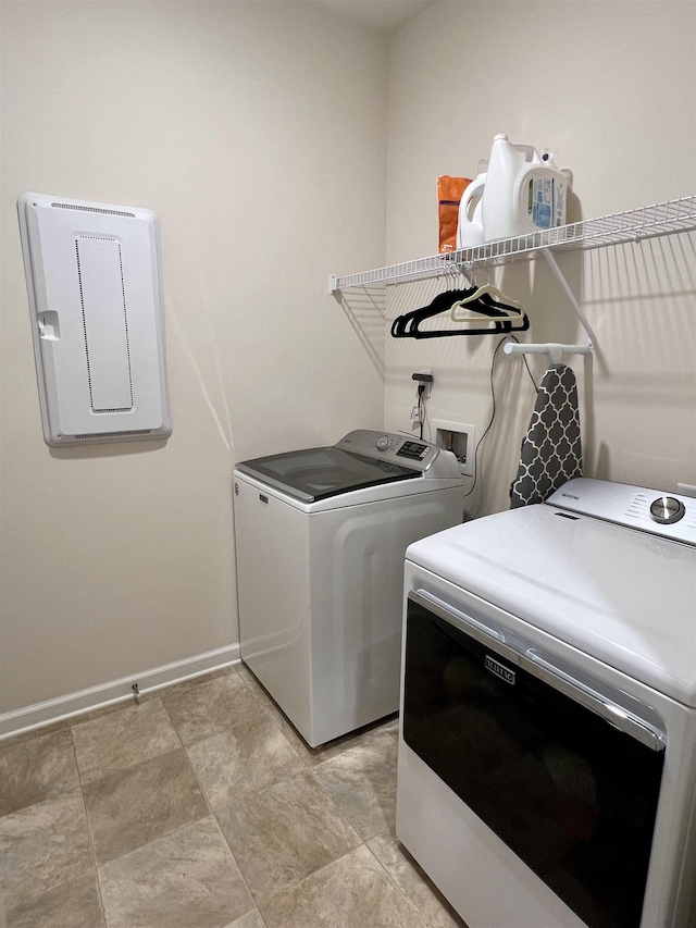 clothes washing area with laundry area, independent washer and dryer, and baseboards