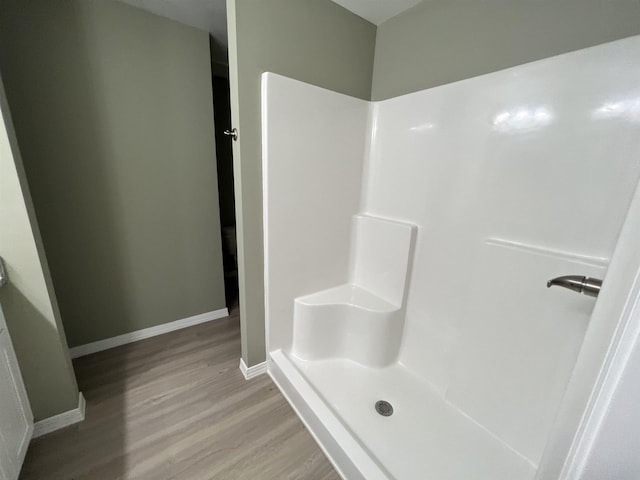 bathroom featuring hardwood / wood-style floors and walk in shower