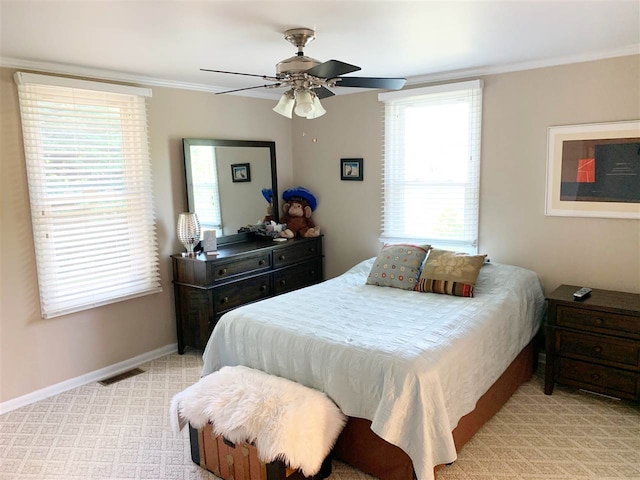 carpeted bedroom with ceiling fan and ornamental molding