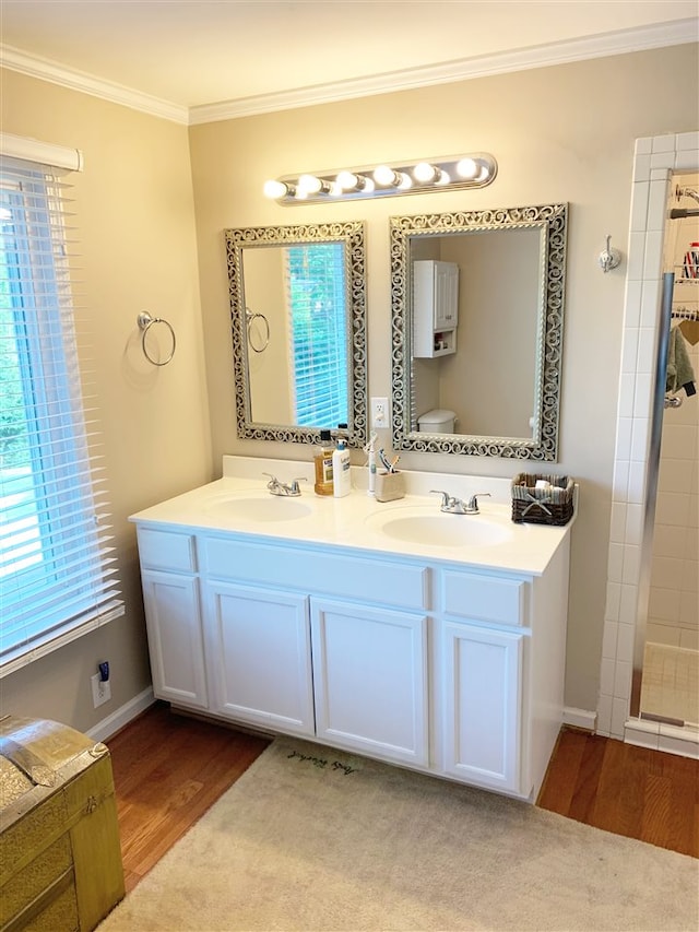 bathroom with crown molding, hardwood / wood-style floors, a shower, toilet, and vanity