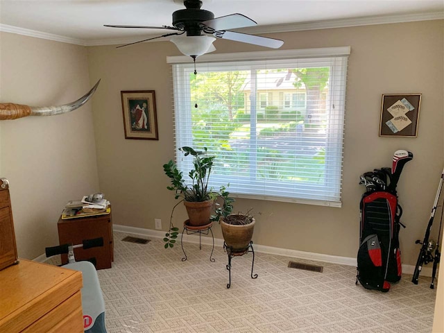 interior space featuring ceiling fan, crown molding, and light carpet