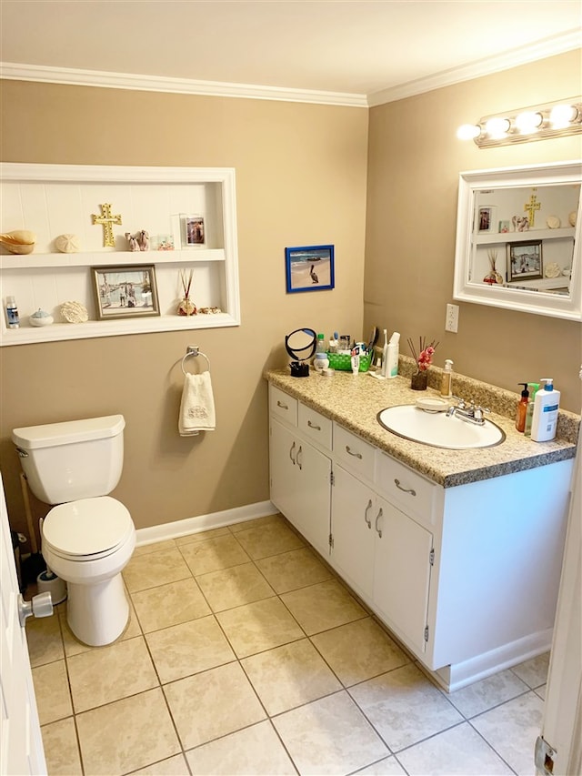 bathroom featuring built in shelves, vanity, crown molding, tile patterned flooring, and toilet