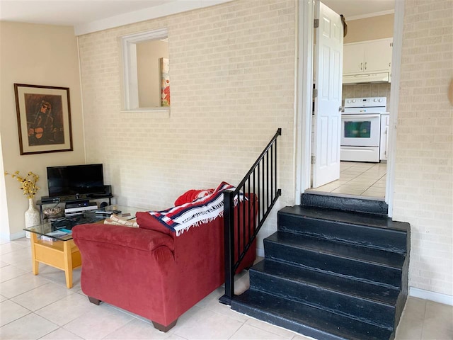 living room with light tile patterned flooring and brick wall