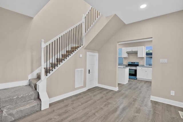 stairway with hardwood / wood-style floors