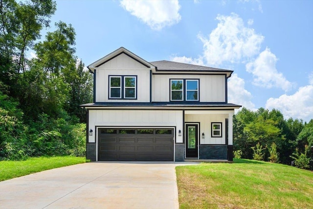 view of front of house with a garage and a front lawn