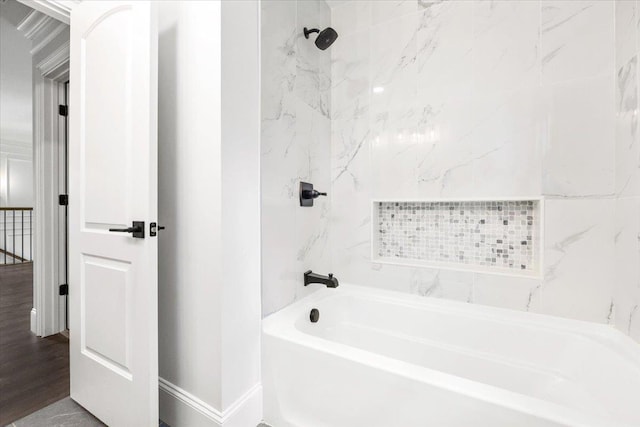 bathroom featuring hardwood / wood-style floors and tiled shower / bath combo