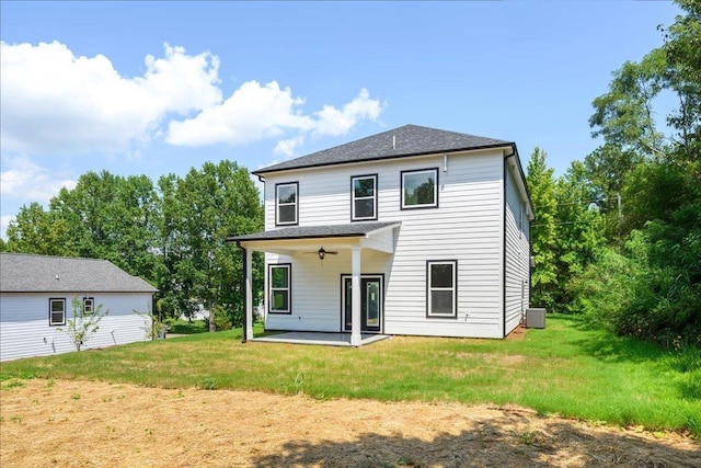 rear view of property featuring a patio, central AC unit, ceiling fan, and a lawn