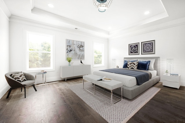 bedroom with a tray ceiling, dark hardwood / wood-style floors, and ornamental molding