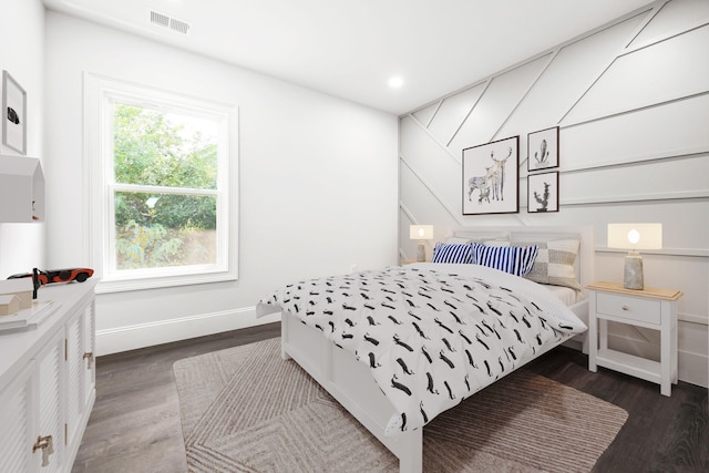 bedroom with dark hardwood / wood-style floors