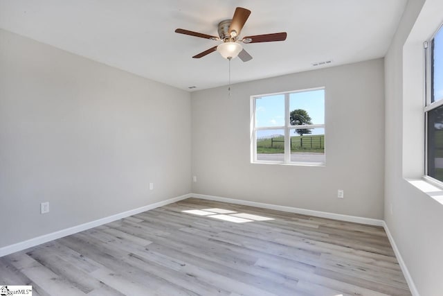 empty room with light hardwood / wood-style flooring and ceiling fan