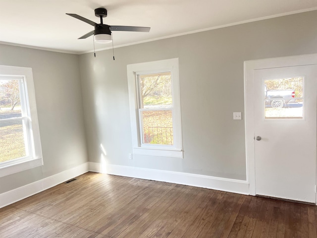 spare room with ceiling fan, wood-type flooring, and crown molding