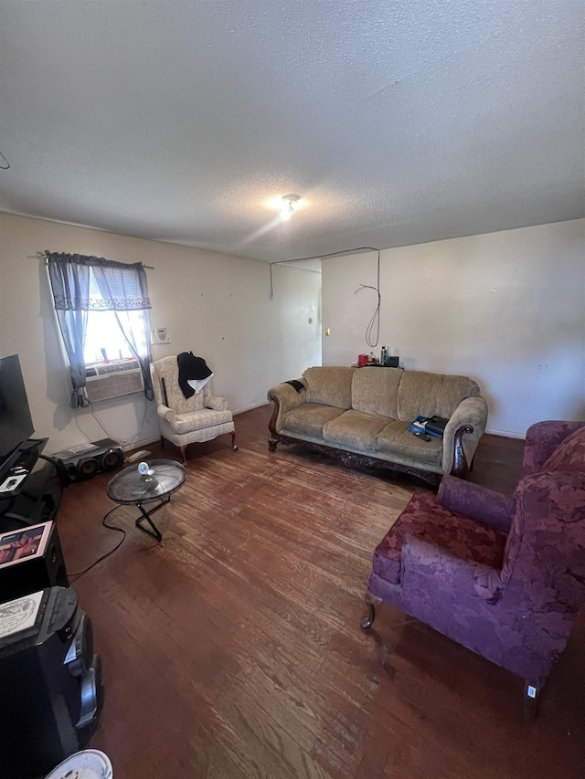 living area featuring a textured ceiling and wood finished floors